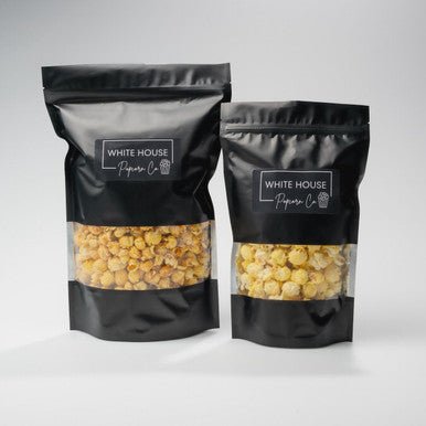Pecan Praline Popcorn available at Whitehousepopcorn.com. Resealable black popcorn bag with window.